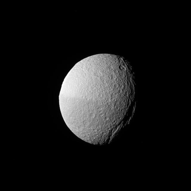 The low angle of the sun over Tethys' massive canyon, Ithaca Chasma (near the terminator, at right), highlights the contours of this enormous rift. Ithaca Chasma is up to 60 miles (100 kilometers) wide, and runs nearly three-fourths of the way around icy Tethys (660 miles or 1,062 kilometers across). The canyon has a maximum depth of nearly 2.4 miles (4 kilometers) deep. The giant crater Odysseus -- usually one of Tethys' most recognizable features-- is barely seen in profile along the limb, at upper left. This view looks toward the Saturn-facing hemisphere of Tethys. North on Tethys is up and rotated 5 degrees to the left. The image was taken in green light with the Cassini spacecraft narrow-angle camera on Jan. 30, 2017. The view was obtained at a distance of approximately 221,000 miles (356,000 kilometers) from Tethys. Image scale is 1 mile (2 kilometers) per pixel. https://photojournal.jpl.nasa.gov/catalog/PIA20527