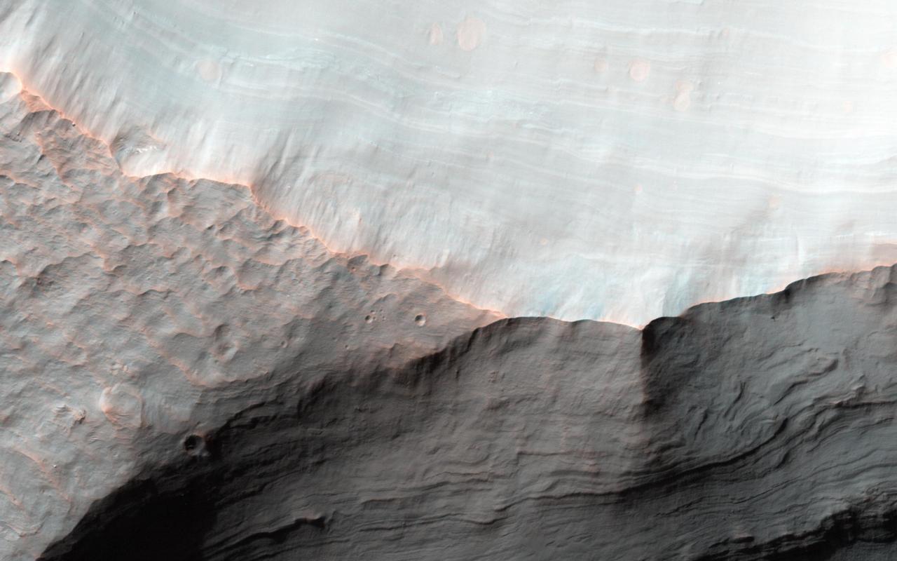 Alluvial fans are gently-sloping wedges of sediments deposited by flowing water. Some of the best-preserved alluvial fans on Mars are in Saheki Crater, seen here by NASA Mars Reconnaissance Orbiter spacecraft.