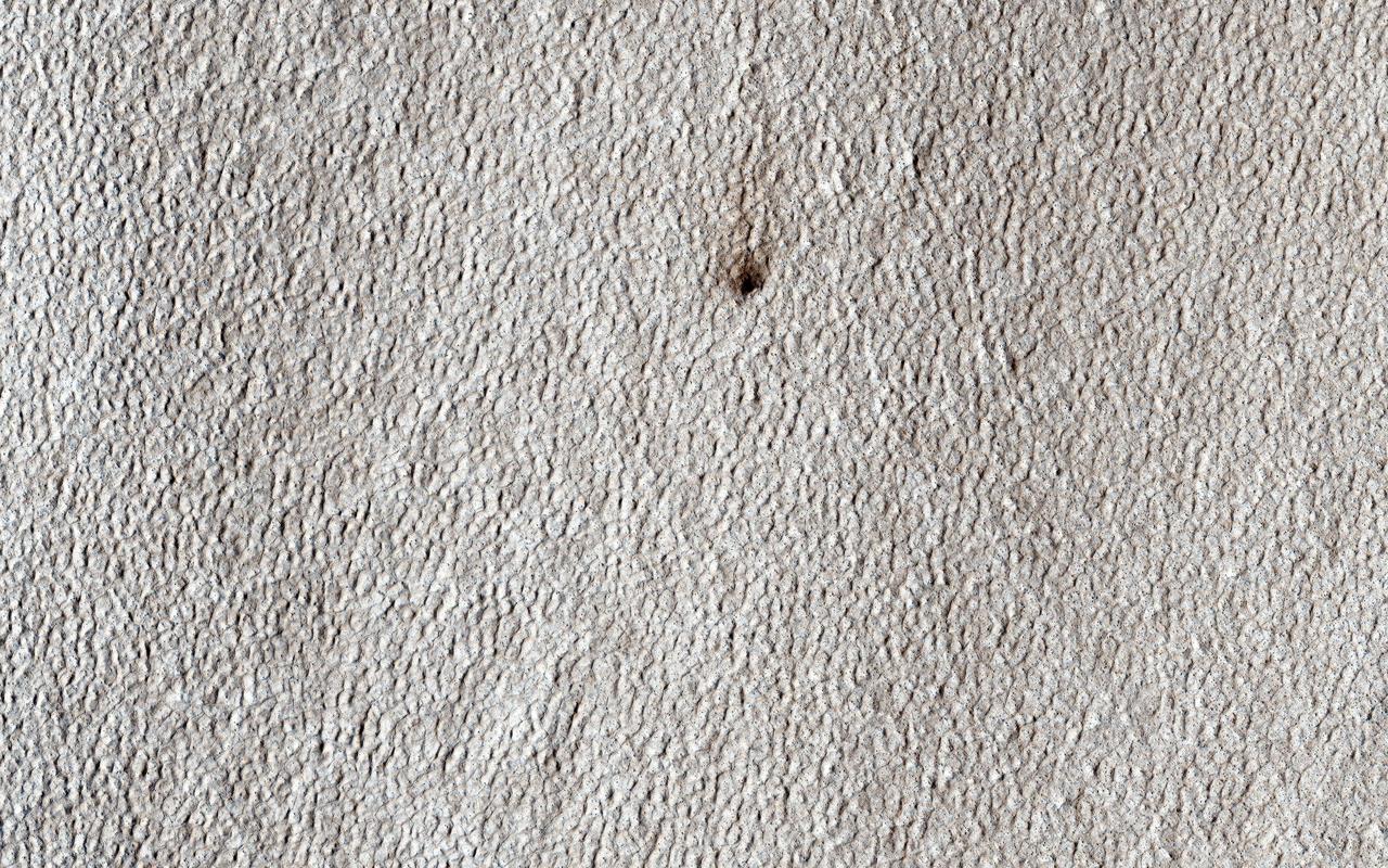 This image was targeted for NASA Mars Reconnaissance Orbiter spacecraft to look at a candidate new crater on a lobate apron. Such aprons are often ice-rich, but the crater shows no bright material that would indicate ice.