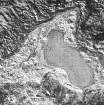 NASA New Horizons spacecraft captured this feature which appears to be a frozen, former lake of liquid nitrogen, located in a mountain range just north of Pluto informally named Sputnik Planum.
