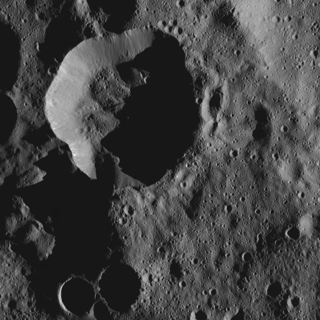 Shadows cast a dark mood on this scene from Ceres, near the dwarf planet north pole in this image acquired by NASA Dawn spacecraft.