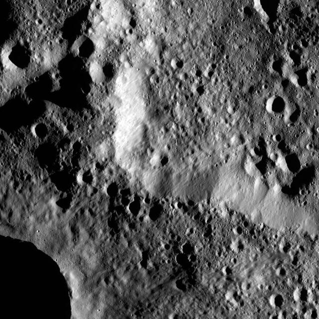 The rim of Hamori Crater on Ceres is seen in the upper right portion of this image, which was taken by NASA Dawn spacecraft. Hamori is located in the southern hemisphere of Ceres and measures 37 miles 60 kilometers wide.