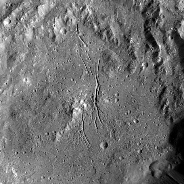 NASA Dawn spacecraft shows Azacca Crater has a prominent set of north-south trending fractures. Its floor is relatively smooth and its rim has terraces descending toward its floor. Azacca was named for the Haitian god of agriculture.