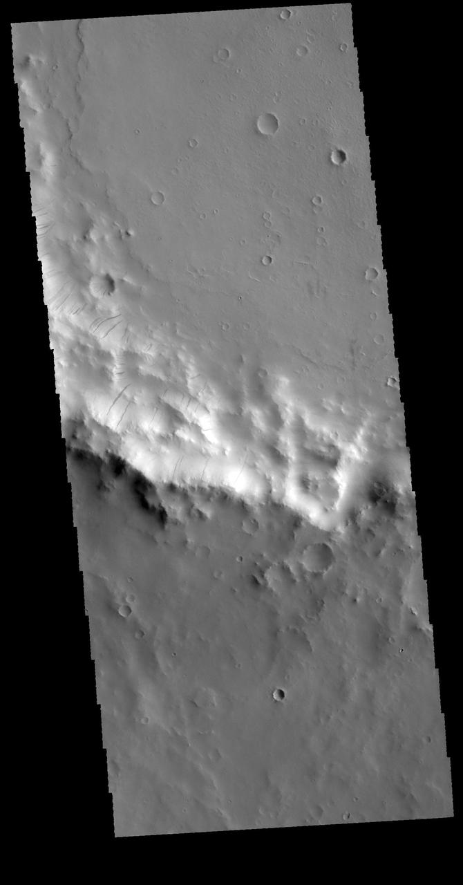 This image captured by NASA 2001 Mars Odyssey spacecraft shows part of the rim of an unnamed crater in Terra Sabaea.