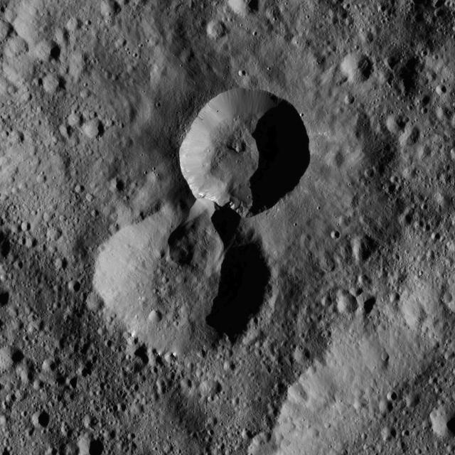 This pair of craters is located in the northern hemisphere of Ceres as seen by NASA Dawn spacecraft. The wall of the older crater lower of the two has partially collapsed where it adjoins the rim of its younger neighbor.