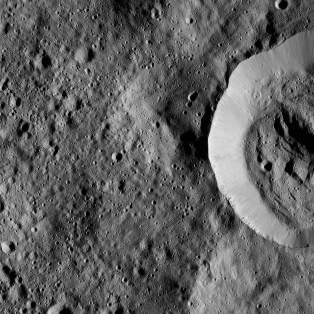 This view from NASA Dawn spacecraft features the sharp rim of a steep-walled crater on Ceres.