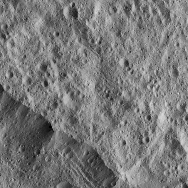 This picture from NASA Dawn spacecraft shows a portion of the northeastern rim of Yalode Crater, one of the largest impact features on Ceres. A set of narrow, roughly parallel fractures can be seen at top center.
