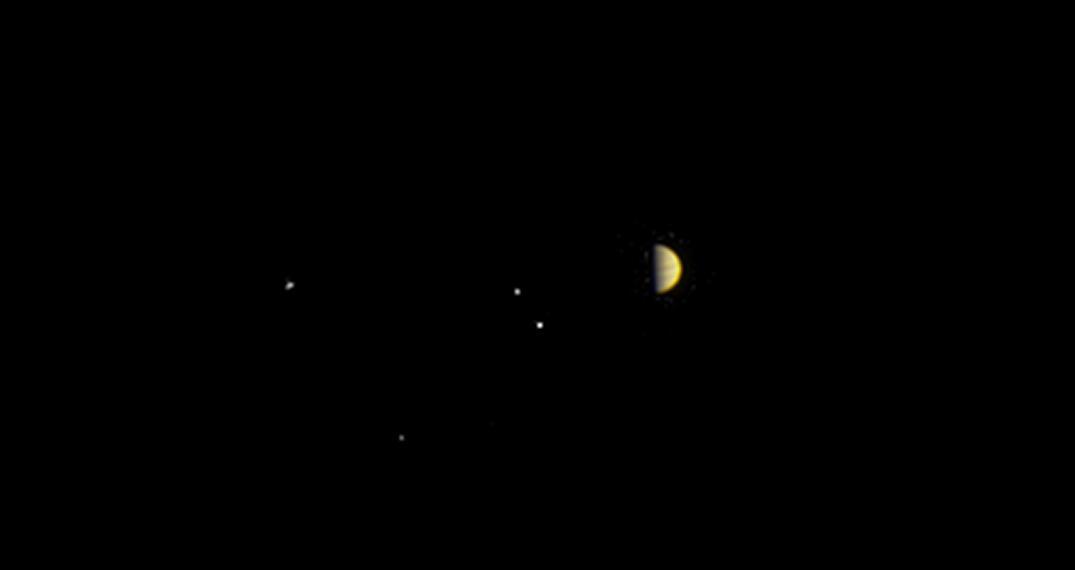 NASA's Juno spacecraft obtained this color view on June 21, 2016, at a distance of 6.8 million miles (10.9 million kilometers) from Jupiter.  As Juno makes its initial approach, the giant planet's four largest moons -- Io, Europa, Ganymede and Callisto -- are visible, and the alternating light and dark bands of the planet's clouds are just beginning to come into view.  Juno is approaching over Jupiter's north pole, affording the spacecraft a unique perspective on the Jupiter system. Previous missions that imaged Jupiter on approach saw the system from much lower latitudes, closer to the planet's equator.  The scene was captured by the mission's imaging camera, called JunoCam, which is designed to acquire high resolution views of features in Jupiter's atmosphere from very close to the planet.  http://photojournal.jpl.nasa.gov/catalog/PIA20701