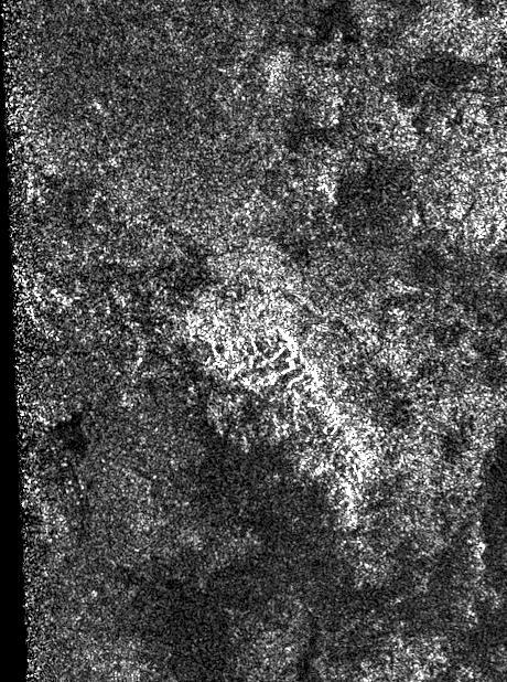 This synthetic-aperture radar image was obtained by NASA's Cassini spacecraft during its T-120 pass over Titan's southern latitudes on June 7, 2016.  The area shown here measures about 40 by 60 miles (70 by 100 kilometers) and is centered at about 60 degrees south latitude, 130 degrees west longitude. Radar illuminates the scene from the left at a 28-degree incidence angle.  At the center of the image is a bright feature oriented from upper left to lower right. This is interpreted to be a long ridge with jagged peaks, likely created by methane rainfall erosion. Some of the individual peaks rise about 2,400 feet (800 meters) above the valley floor. The ridge has a considerably gentler slope on its left side (which appears brighter here) than on its right. Frequently, mountains shaped like this on Earth are fractured blocks of the planet's crust, thrusted upward and then tilted, creating a shallow slope on one side and a steeper slope on the fractured, faulted edge.  Also presented here is an annotated version of the image, along with a radar image of the Dragoon Mountains in Arizona just east of Tucson. The Dragoon feature represents a tilted fault block, formed by spreading that has occurred across the western U.S., and has a similar shape to that of the Titan ridge. The Dragoon radar image was produced using data from NASA's Shuttle Radar Topography Mission (credit: NASA/JPL-Caltech/NGA). Radar illuminates the scene from the left in that image as well.  Titan has displayed many features that are strikingly similar to Earth: lakes, seas, rivers, dunes and mountains. Scientists think it possible that, like Earth, the giant moon's crust has experienced familiar processes of uplift and spreading, followed by erosion.  http://photojournal.jpl.nasa.gov/catalog/PIA20709