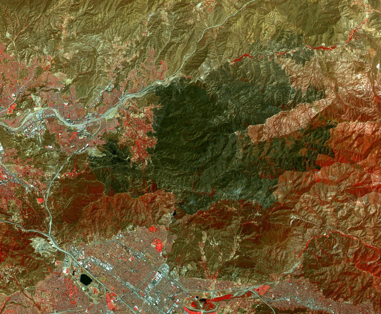 The Sand fire, in the mountains northwest of Los Angeles, has burned more than 39,000 acres, destroyed 18 houses, and caused one fatality. By August 1, 2016, when the Advanced Spaceborne Thermal Emission and Reflection Radiometer (ASTER) instrument on NASA's Terra spacecraft acquired this image, the fire was more than 90 percent contained. The fire began 10 days earlier in a brushy area near Highway 14. It grew explosively to thousands of acres, driven by high winds and temperatures over 100 degrees Fahrenheit. At one time, more than 20,000 residents were evacuated from their homes. In this image, vegetation is displayed in red, and the burn area is dark grey to black. The image covers an area of 16.4 by 19.4 miles (26.4 by 31.3 kilometers), and is located at 34.4 degrees north, 118.3 degrees west. http://photojournal.jpl.nasa.gov/catalog/PIA20723
