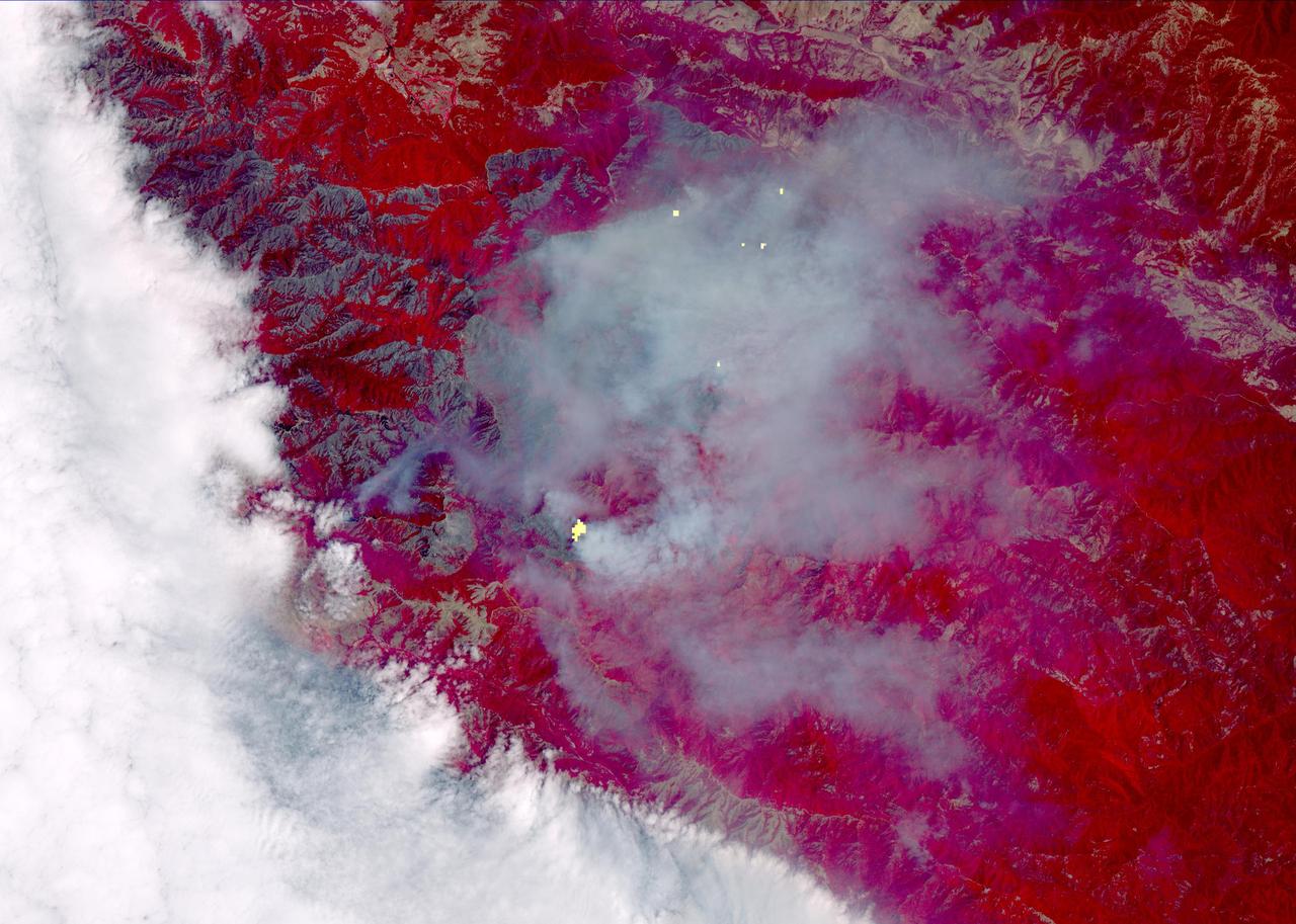 The Soberanes fire, in Central California near Big Sur, had grown to more than 67,000 acres when the Advanced Spaceborne Thermal Emission and Reflection Radiometer (ASTER) instrument on NASA's Terra spacecraft captured this image on Aug. 6, 2016. More than 4,800 personnel are battling the blaze, which is now 50 percent contained. The fire has destroyed 57 homes and 11 outbuildings and caused one fatality. Evacuation orders are still in effect for a number of nearby communities. The fire was caused by an illegal unattended campfire. Vegetation is depicted in red colors; burned areas are dark grey; clouds are white; smoke and ash are light grey. Yellow indicates active fires, detected on ASTER's thermal infrared channels. The image covers an area of 19 by 26 miles (30 by 42 kilometers), and is located at 36.4 degrees north, 121.8 degrees west.  http://photojournal.jpl.nasa.gov/catalog/PIA20725