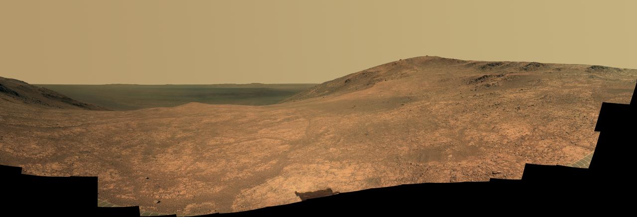 "Marathon Valley" on Mars opens northeastward to a view across the floor of Endeavour Crater in this scene from the panoramic camera (Pancam) of NASA's Mars Exploration Rover Opportunity. The scene merges multiple Pancam exposures taken during the period April 16 through May 15, 2016, corresponding to sols (Martian days) 4,347 through 4,375 of Opportunity's work on Mars. It spans from north, at the left, to west-southwest, at the right. The high point in the right half of the scene is "Knudsen Ridge," which forms part of the southern edge of Marathon Valley. Portions of the northeastern and eastern rim of Endeavour crater appear on the distant horizon. Endeavour Crater is 14 miles (22 kilometers) in diameter. The fractured texture of Marathon Valley's floor is visible in the foreground. The view merges exposures taken through three of the Pancam's color filters, centered on wavelengths of 753 nanometers (near-infrared), 535 nanometers (green) and 432 nanometers (violet). It is presented in approximately true color. The rover team calls this image the mission's "Sacagawea Panorama," for the Lemhi Shoshone woman, also commemorated on U.S. dollar coins, whose assistance to the Lewis and Clark expedition helped enable its successes in 1804-1806. Many rocks and other features in Marathon Valley were informally named for members of Lewis and Clark's "Corps of Discovery" expedition. Opportunity entered Marathon Valley in July 2015. The valley's informal name was chosen because Opportunity's arrival at this point along the western rim of Endeavour Crater coincided closely with the rover surpassing marathon-footrace distance in its total driving odometry since landing on Mars in January 2004. The team's planned investigations in the valley were nearing completion when the component images for this scene were taken. http://photojournal.jpl.nasa.gov/catalog/PIA20749