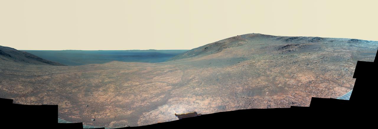 "Marathon Valley" on Mars opens northeastward to a view across the floor of Endeavour Crater in this scene from the panoramic camera (Pancam) of NASA's Mars Exploration Rover Opportunity. In this version of the scene the landscape is presented in enhanced color to make differences in surface materials more easily visible. The panorama merges multiple Pancam exposures taken during the period April 16 through May 15, 2016, corresponding to sols (Martian days) 4,347 through 4,375 of Opportunity's work on Mars. It spans from north, at the left, to west-southwest, at the right. The high point in the right half of the scene is "Knudsen Ridge," which forms part of the southern edge of Marathon Valley. Portions of the northeastern and eastern rim of Endeavour crater appear on the distant horizon. Endeavour Crater is 14 miles (22 kilometers) in diameter. The fractured texture of Marathon Valley's floor is visible in the foreground. The rover team calls this image the mission's "Sacagawea Panorama," for the Lemhi Shoshone woman, also commemorated on U.S. dollar coins, whose assistance to the Lewis and Clark expedition helped enable its successes in 1804-1806. Many rocks and other features in Marathon Valley were informally named for members of Lewis and Clark's "Corps of Discovery" expedition. Opportunity entered Marathon Valley in July 2015. The valley's informal name was chosen because Opportunity's arrival at this point along the western rim of Endeavour Crater coincided closely with the rover surpassing marathon-footrace distance in its total driving odometry since landing on Mars in January 2004. The team's planned investigations in the valley were nearing completion when the component images for this scene were taken. http://photojournal.jpl.nasa.gov/catalog/PIA20750