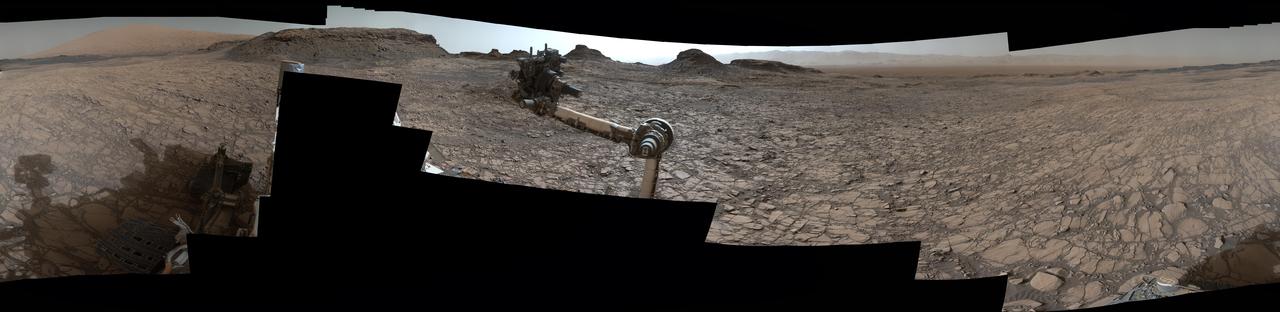 This 360-degree panorama was acquired by the Mast Camera (Mastcam) on NASA's Curiosity Mars rover as the rover neared features called "Murray Buttes" on lower Mount Sharp.  The view combines more than 130 images taken on Aug. 5, 2016, during the afternoon of the mission's 1,421st sol, or Martian day, by Mastcam's left-eye camera. This date also was the fourth anniversary of Curiosity's landing.  The dark, flat-topped mesa seen to the left of Curiosity's robotic arm is about 300 feet (about 90 meters) from the rover's position. It stands about 50 feet (about 15 meters) high. The horizontal ledge near the top of the mesa is about 200 feet (about 60 meters) across. An upper portion of Mount Sharp appears on the distant horizon to the left of this mesa.  The relatively flat foreground is part of a geological layer called the Murray formation, which formed from lakebed mud deposits. The buttes and mesas rising above this surface are eroded remnants of ancient sandstone that originated when winds deposited sand after lower Mount Sharp had formed. Curiosity closely examined that layer -- the Stimson formation -- during the first half of 2016 while crossing a feature called "Naukluft Plateau" between two exposures of the Murray formation.  The buttes and mesas of Murray Buttes are capped by material that is relatively resistant to erosion, just as is the case with many similarly shaped buttes and mesas on Earth. The informal naming honors Bruce Murray (1931-2013), a Caltech planetary scientist and director of NASA's Jet Propulsion Laboratory, Pasadena, California.  The scene is presented with a color adjustment that approximates white balancing, to resemble how the rocks and sand would appear under daytime lighting conditions on Earth.   http://photojournal.jpl.nasa.gov/catalog/PIA20765