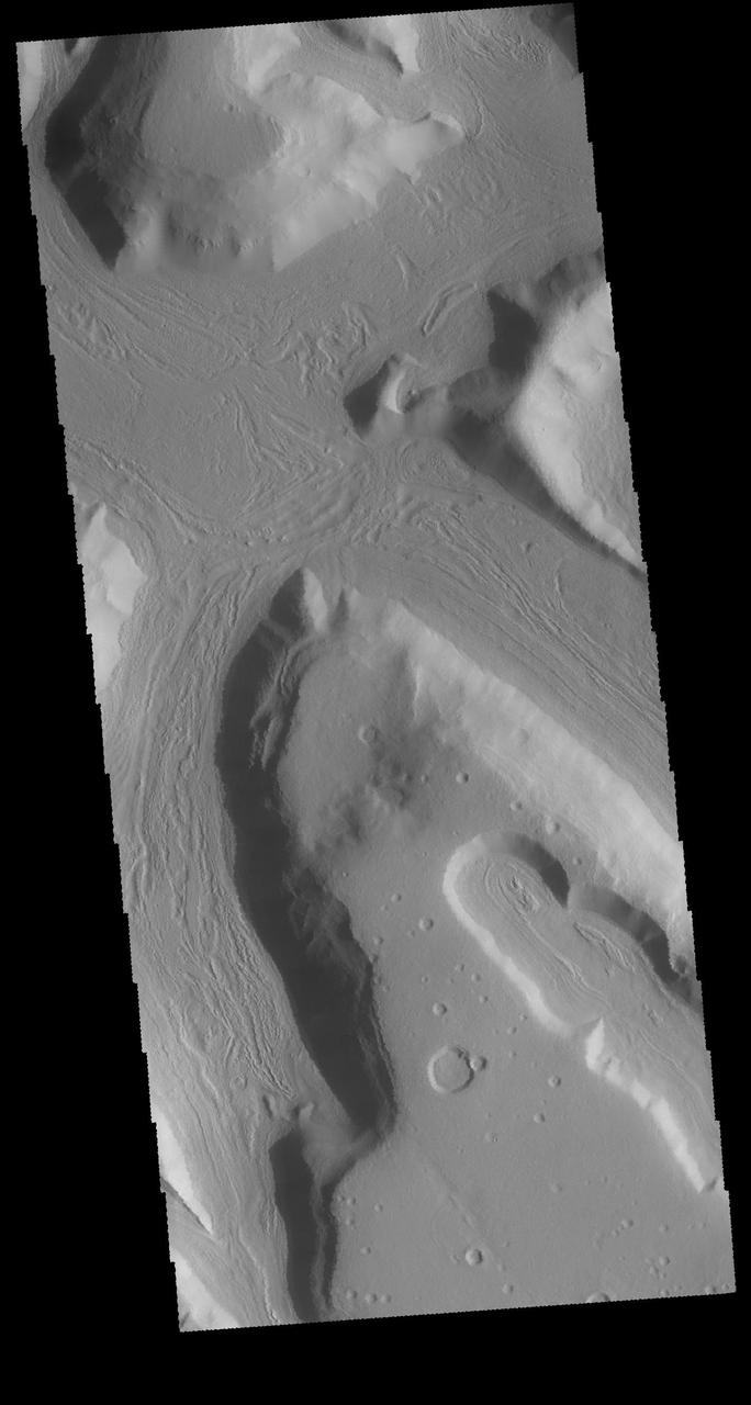 This image captured by NASA 2001 Mars Odyssey spacecraft is located on the eastern margin of Terra Sabaea. The boundary region between the highlands of Terra Sabaea and the lower elevations of Utopia Planitia is a complex of channels, chaos and graben. Orbit Number: 63956 Latitude: 35.3885 Longitude: 56.728 Instrument: VIS Captured: 2016-05-14 22:55 http://photojournal.jpl.nasa.gov/catalog/PIA20781