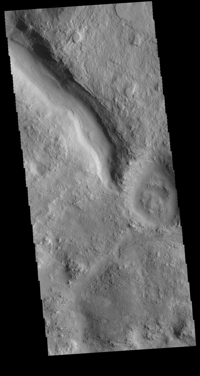 This image captured by NASA 2001 Mars Odyssey spacecraft shows a short section of channel between two craters in Terra Sabaea. One crater is outside the image area at the upper left of the image. The channel appears to stop in the center of the image, which is the location of the rim of the second crater. Orbit Number: 64018 Latitude: 29.7122 Longitude: 68.385 Instrument: VIS Captured: 2016-05-20 01:27 http://photojournal.jpl.nasa.gov/catalog/PIA20784