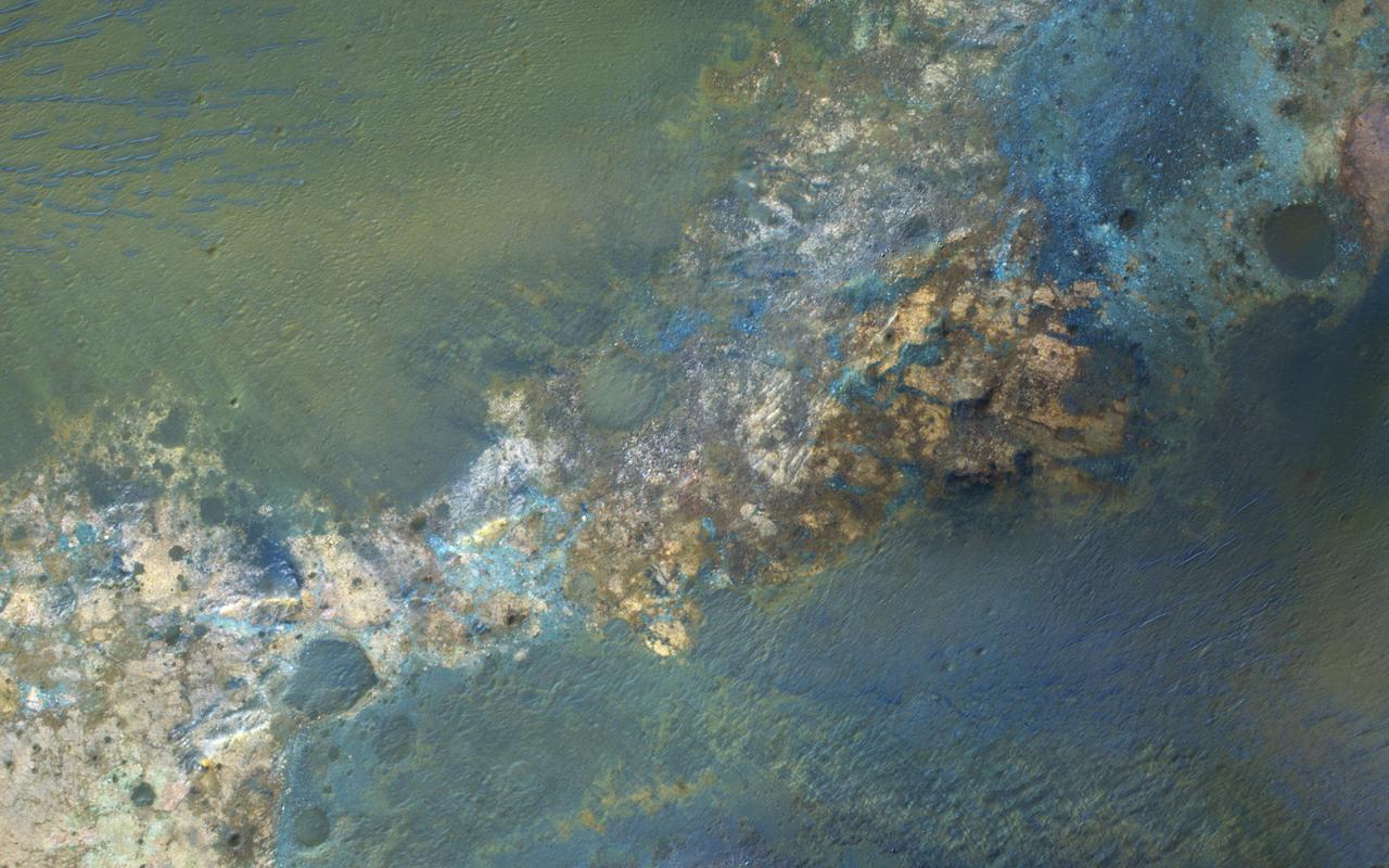 Large impact craters rebound from the initial shock, raising deep bedrock to the surface in the central uplift of the crater. Often this bedrock has greater compositional diversity than the surface layers, because they are from greater depths, older, jumbled, and altered, and very diverse. http://photojournal.jpl.nasa.gov/catalog/PIA20814