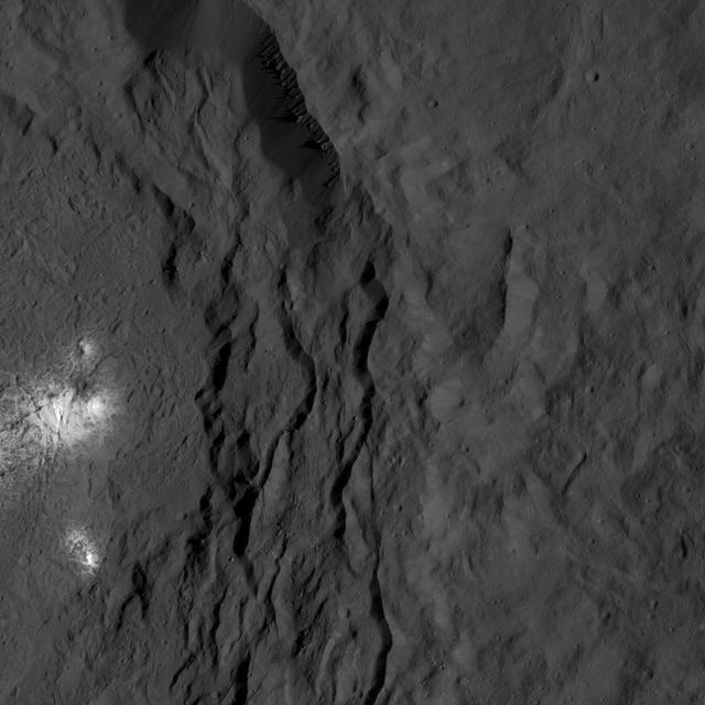 A cluster of bright areas in Ceres Occator Crater are seen in this image from NASA Dawn spacecraft. These areas are not as bright as the material at the center of the crater.  Dawn took this image on June 16, 2016, from its low-altitude mapping orbit, at a distance of about 240 miles (385 kilometers) above the surface. The image resolution is 120 feet (35 meters) per pixel.  http://photojournal.jpl.nasa.gov/catalog/PIA20831