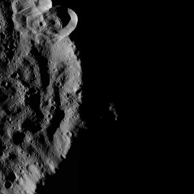 The rim of the crater blocks sunlight coming from the right, creating a moody scene on Ceres. The image is centered at approximately 76 degrees south latitude, 155 degrees east longitude. NASA's Dawn spacecraft took this image on June 16, 2016, from its low-altitude mapping orbit, at a distance of about 240 miles (385 kilometers) above the surface. The image resolution is 120 feet (35 meters) per pixel. http://photojournal.jpl.nasa.gov/catalog/PIA20832
