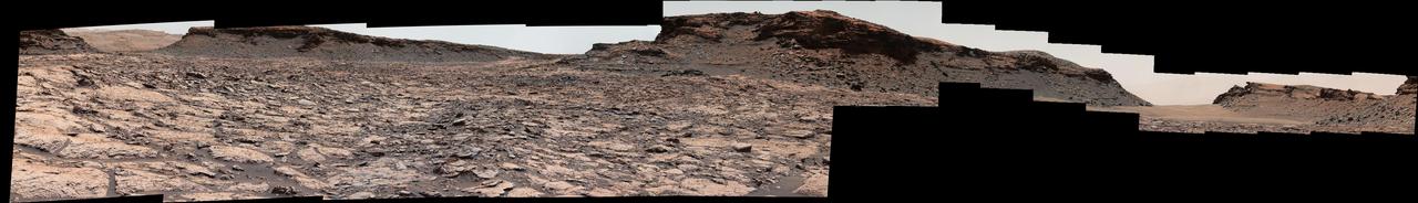 The mesa in the center of this scene from the "Murray Buttes" area on Mars' lower Mount Sharp is longer than a football field. It extends more than 361 feet (110 meters) from the left-most outcrop low on the slope to the right side where rock debris is behind a light-toned, dust-covered dune.  The panorama combines sets of images taken by the left-eye camera of the Mast Camera (Mastcam) on NASA's Curiosity Mars rover, for the left half of the scene, and by Mastcam's right-eye camera for the right half of the scene. The component images from the left-eye camera were taken on Aug. 22, 2016, during the 1,438th Martian day, or sol, of the rover's work on Mars. The ones from the right-eye camera, which has a telephoto lens, were taken the following day, on Sol 1439.  From the rover's position when the component images were taken, the top of the central mesa is about 310 feet (about 95 meters) away and about 52 feet (about 16 meters) above the rover.  The relatively flat foreground is part of a geological layer called the Murray formation, which includes lakebed mud deposits. The buttes and mesas rising above this surface are eroded remnants of ancient sandstone that originated when winds deposited sand after lower Mount Sharp had formed. They are capped by material that is relatively resistant to erosion, just as is the case with many similarly shaped buttes and mesas on Earth.  The scene is presented with a color adjustment that approximates white balancing, to resemble how the rocks and sand would appear under daytime lighting conditions on Earth.  http://photojournal.jpl.nasa.gov/catalog/PIA20842