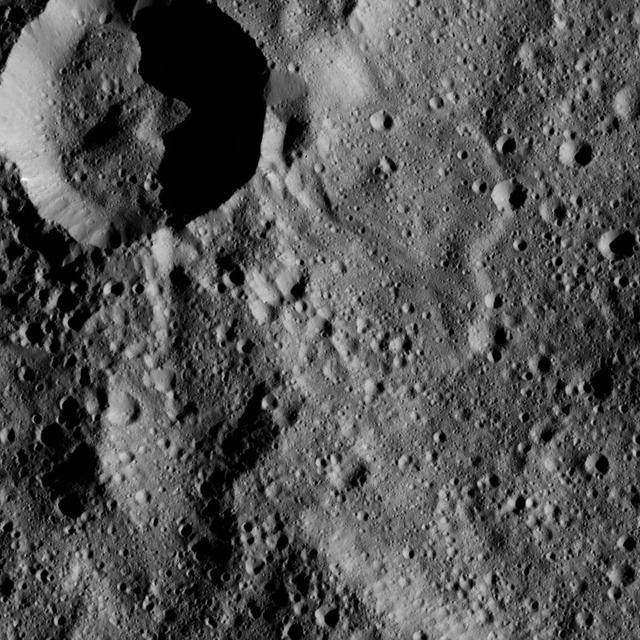 Liber Crater is featured at lower left in this image from Ceres. Named for the Roman god of agriculture, Liber is 14 miles (23 kilometers) wide. NASA's Dawn spacecraft took this image on June 16, 2016, from its low-altitude mapping orbit, at a distance of about 240 miles (385 kilometers) above the surface. The image resolution is 120 feet (35 meters) per pixel. http://photojournal.jpl.nasa.gov/catalog/PIA20834