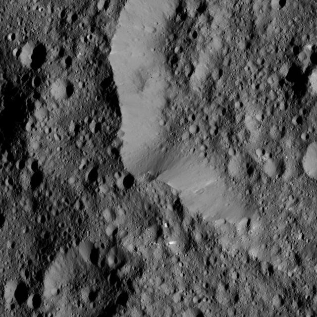 This view from NASA's Dawn spacecraft shows the rim of Ernutet Crater (32 miles, 52 kilometers in diameter) on Ceres.  NASA's Dawn spacecraft took this image on June 17, 2016, from its low-altitude mapping orbit, at a distance of about 240 miles (385 kilometers) above the surface. The image resolution is 120 feet (35 meters) per pixel.  http://photojournal.jpl.nasa.gov/catalog/PIA20862