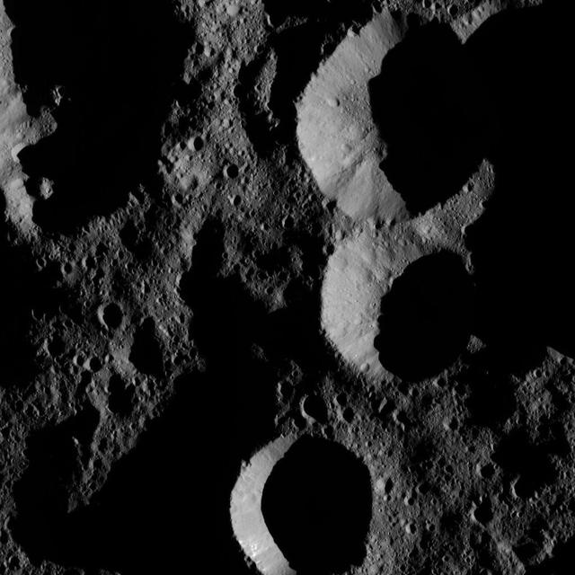 NASA's Dawn spacecraft obtained this view of shadowed craters near Ceres' north pole. Ceres has only a modest tilt of a few degrees to its rotational axis, so its polar regions do not experience drastic changes in the sun's angle and length of day like Earth's extreme north and south.  The image is centered at approximately 73 degrees north latitude, 246 degrees east longitude.  Dawn took this image on May 28, 2016, from its low-altitude mapping orbit, at a distance of about 240 miles (385 kilometers) above the surface. The image resolution is 120 feet (35 meters) per pixel.  http://photojournal.jpl.nasa.gov/catalog/PIA20875