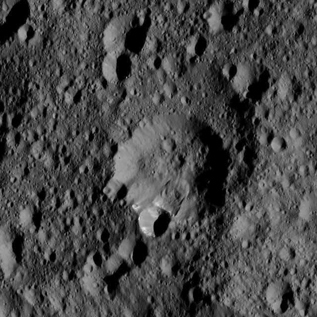 An area along the rim of the crater at the center of this view from NASA Dawn spacecraft, has collapsed, producing a lobe-shaped feature where the material settled. The image is centered at approximately 52 degrees north latitude, 316 degrees east longitude. NASA's Dawn spacecraft took this image on May 28, 2016, from its low-altitude mapping orbit, at a distance of about 240 miles (385 kilometers) above the surface of Ceres. The image resolution is 120 feet (35 meters) per pixel. http://photojournal.jpl.nasa.gov/catalog/PIA20880