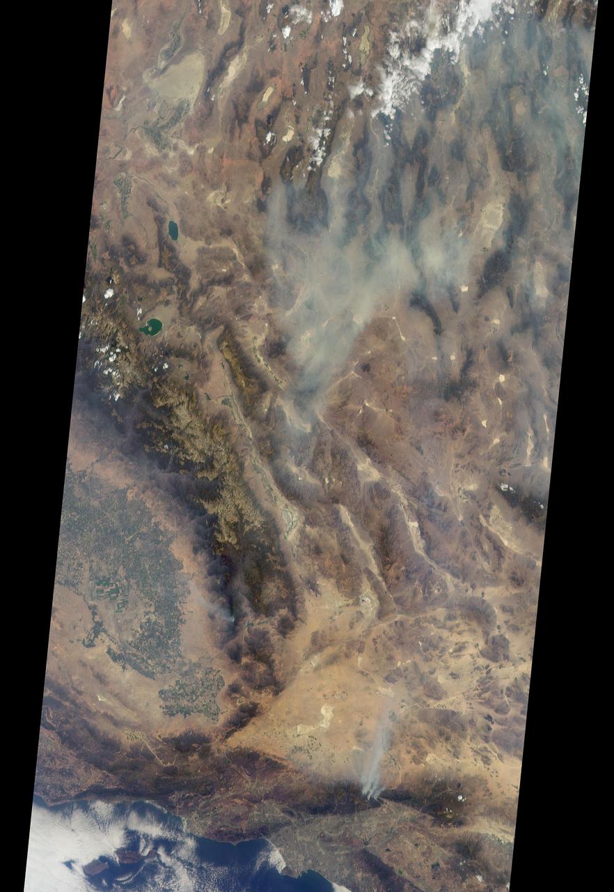 On Aug. 16, 2016, at around 10:30 a.m., a brush fire ignited in the Cajon Pass east of Los Angeles, just to the west of Interstate 15. Within a matter of hours, extreme temperatures, high winds and low humidity allowed the fire to spread rapidly, burning through brush left tinder-dry by years of drought. Firefighters quickly responded, ordering the evacuation of about 83,000 people in and around the Cajon Pass, Wrightwood, Lytle Creek, Oak Hills and surrounding areas. An as-yet uncounted number of homes and structures have burned, and Interstate 15 remains closed to downed power lines and barrier damage. By Aug. 17, the fire had expanded to more than 30,000 acres and remains zero percent contained as some 1,300 firefighters continue to battle to save homes and evacuate residents.  The Multi-angle Imaging SpectroRadiometer (MISR) instrument aboard NASA's Terra satellite passed over the region on Aug. 17 around 11:50 a.m. PDT and captured this natural-color image from MISR's 70-degree forward-viewing camera, which covers an areas about 257 miles (414 kilometers) wide. The oblique view angle makes the smoke more apparent than it would be in a more conventional vertical view. The Los Angeles metropolitan area is the large gray area on the coast in the center of the image. Three plumes from the Blue Cut Fire are clearly visible in the mountains to the north. This oblique view also shows an enormous cloud of smoke spreading northeastward over a significant portion of eastern California and Nevada. This smoke probably originated from the fire as it consumed almost 20,000 acres on the evening of the 16th and traveled north overnight.  Also visible from this oblique view is considerable haziness filling California's Central Valley, to the northwest of the Blue Cut Fire. This haziness is most likely due to smoke from several other fires burning in California, including the Soberanes Fire near Monterey, the Clayton Fire that has destroyed 175 structures north of San Francisco, the Chimney Fire and the Cedar Fire, which is visible in the image in the southern Sierra Nevada. The total number of acres burned in California this year has tripled in just the past week.  The 3D stereo anaglyph is made by combining data from MISR's 60-degree and 70-degree forward-viewing cameras. You will need red-blue glasses to view the 3D effect (ensure the red lens is over your left eye). In order to enable stereo viewing, the image has been rotated so north is to the left.  These data were acquired during Terra orbit 88648.  http://photojournal.jpl.nasa.gov/catalog/PIA20888