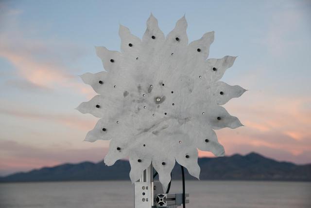 A test of a small-scale starshade model (58 cm), made from metal, in a dry lake bed in central Nevada's Smith Creek, took place from May to June 2014. Nineteen different versions of the miniaturized starshade were tested over five days. The tests revealed that a starshade, or external occulter, is capable of blocking starlight to a degree that reveals the relatively dim reflected light of a planet next to its brighter star. Like holding your hand up to block sunlight, the starshade works to block excessive starlight from the "eyes" of a space telescope like Hubble.   http://photojournal.jpl.nasa.gov/catalog/PIA20902