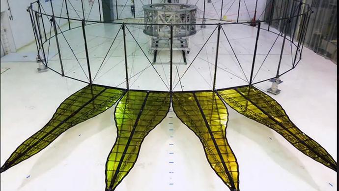 The first prototype starshade developed by NASA's Jet Propulsion Laboratory, shown in technology partner Astro Aerospace/Northrup Grumman's facility in Santa Barbara, California, in 2013. As shown by this 66 foot (20-meter) model, starshades can come in many shapes and sizes. This design shows petals that are more extreme in shape which properly diffracts starlight for smaller telescopes. Each petal is covered in a high-performance plastic film that resembles gold foil. On a starshade ready for launch, the thermal gold foil will only cover the side of the petals facing away from the telescope, with black on the other, so as not to reflect other light sources such as the Earth into its camera.  http://photojournal.jpl.nasa.gov/catalog/PIA20906