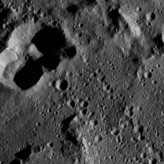 This view from NASA's Dawn spacecraft shows cratered terrain on the edge of the giant crater Yalode. The image is centered at 44 degrees south latitude, 316 degrees east longitude.  Dawn took this image on June 1, 2016, from its low-altitude mapping orbit, at a distance of about 240 miles (385 kilometers) above the surface. The image resolution is 120 feet (35 meters) per pixel.  http://photojournal.jpl.nasa.gov/catalog/PIA20936