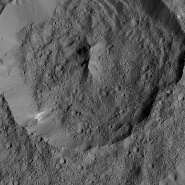 NASA's Dawn spacecraft spies Achita Crater on Ceres in this view. Achita is named for a Nigerian god of agriculture and is 25 miles (40 kilometers) wide. Dawn took this image on June 3, 2016, from its low-altitude mapping orbit, at a distance of about 240 miles (385 kilometers) above the surface. The image resolution is 120 feet (35 meters) per pixel. http://photojournal.jpl.nasa.gov/catalog/PIA20947