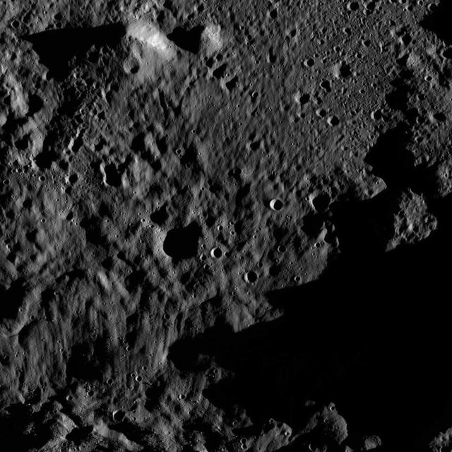 This view from NASA's Dawn spacecraft shows an area within the floor of the Mondamin impact basin, which lies in the southern hemisphere of Ceres. Mondamin Crater is about 78 miles (126 kilometers) in diameter. Dawn took this image on June 3, 2016, from its low-altitude mapping orbit, at a distance of about 240 miles (385 kilometers) above the surface. The image resolution is 120 feet (35 meters) per pixel. http://photojournal.jpl.nasa.gov/catalog/PIA20948