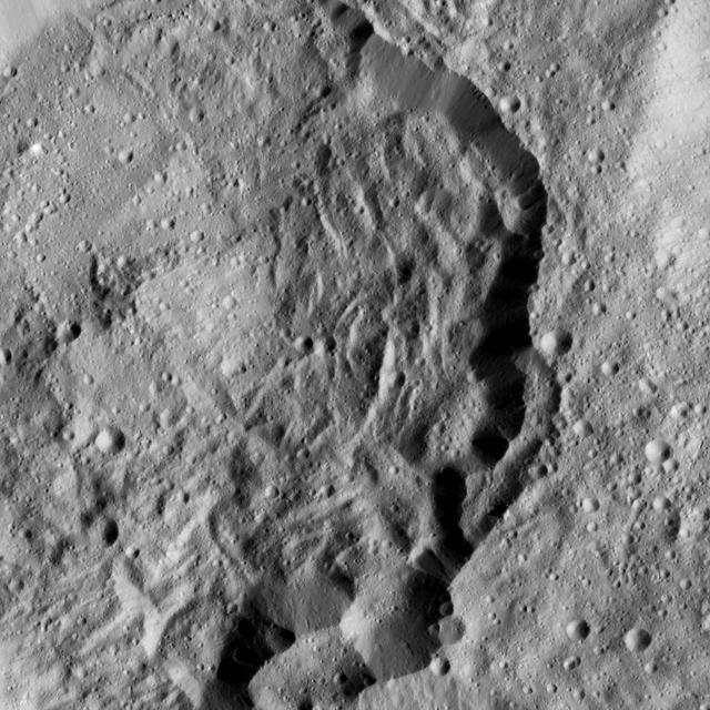 This image from NASA's Dawn spacecraft shows Kondos Crater on Ceres. The image is centered at 19 degrees south latitude, 18 degrees east longitude. Dawn took this image on June 10, 2016, from its low-altitude mapping orbit, at a distance of about 240 miles (385 kilometers) above the surface. The image resolution is 120 feet (35 meters) per pixel. http://photojournal.jpl.nasa.gov/catalog/PIA20961