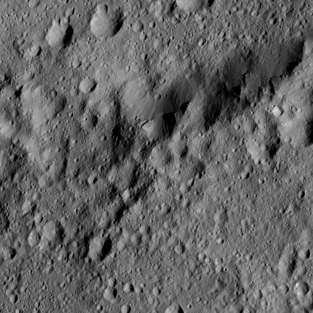 This image from NASA's Dawn spacecraft shows the edge of Ezinu Crater on Ceres. The image is centered at 36 degrees north latitude, 193 degrees east longitude. Dawn took this image on June 10, 2016, from its low-altitude mapping orbit, at a distance of about 240 miles (385 kilometers) above the surface. The image resolution is 120 feet (35 meters) per pixel. http://photojournal.jpl.nasa.gov/catalog/PIA20962