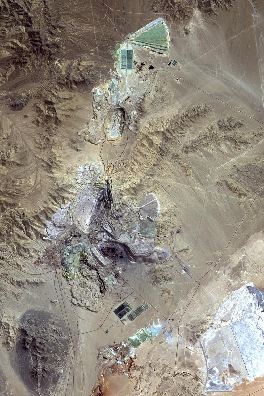 Chuquicamata, in Chile's Atacama Desert, is the largest open pit copper mine in the world, by excavated volume. The copper deposits were first exploited in pre-Hispanic times. Open pit mining began in the early 20th century when a method was developed to work low grade oxidized copper ores. The image was acquired September 2, 2007, covers an area of 19.5 by 29.3 km, and is located at 22.1 degrees south, 68.9 degrees west. http://photojournal.jpl.nasa.gov/catalog/PIA20973