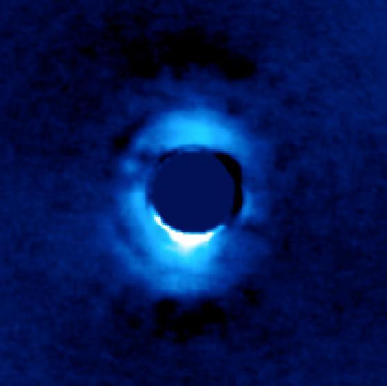 This image shows the dusty disk of planetary material surrounding the young star HD 141569, located 380 light-years away from Earth. It was taken using the vortex coronagraph on the W.M. Keck Observatory. The vortex suppressed light from the star in the center, revealing light from the innermost ring of planetary material around the star (blue).  The disk around the star, made of olivine particles, extends from 23 to 70 astronomical units from the star. By comparison, Uranus is over 19 astronomical units from our sun, and Neptune about 30 astronomical units. One astronomical unit is the distance between Earth and our sun.  http://photojournal.jpl.nasa.gov/catalog/PIA21090