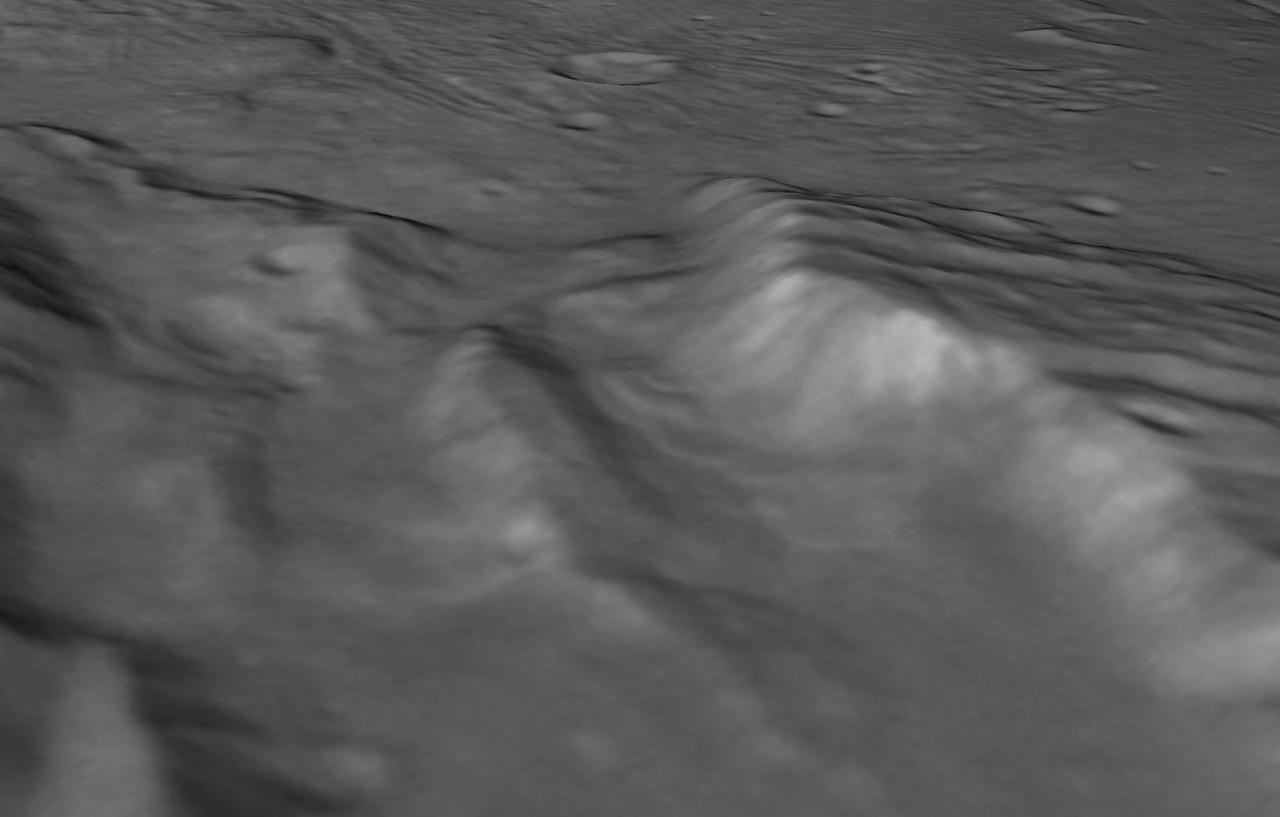 perspective view of Charon's informally named "Serenity Chasm" consists of topography generated from stereo reconstruction of images taken by New Horizons' Long Range Reconnaissance Imager (LORRI) and Multispectral Visible Imaging Camera (MVIC), supplemented by a "shape-from-shading" algorithm.  The topography is then overlain with the PIA21128 image mosaic and the perspective view is rendered. The MVIC image was taken from a distance of 45,458 miles (73,159 kilometers) while the LORRI picture was taken from 19,511 miles (31,401 kilometers) away, both on July 14, 2015.  http://photojournal.jpl.nasa.gov/catalog/PIA21129