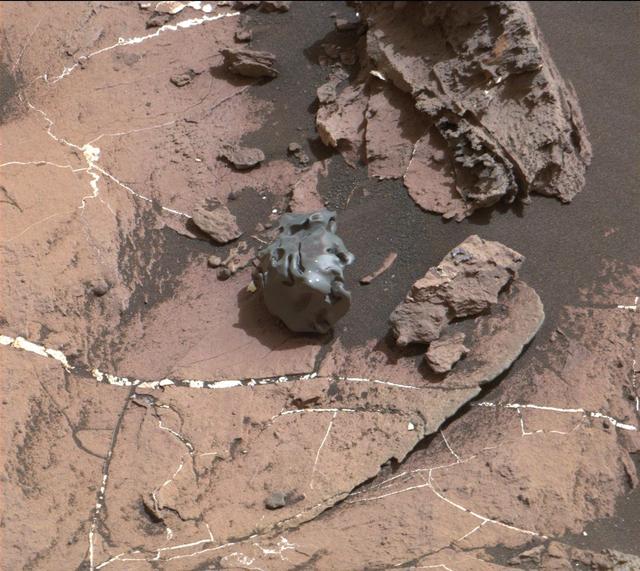 The dark, smooth-surfaced object at the center of this Oct. 30, 2016, image from the Mast Camera (Mastcam) on NASA's Curiosity Mars rover was examined with laser pulses and confirmed to be an iron-nickel meteorite.  The grid of shiny points visible on the object resulted from that laser zapping by Curiosity's Chemistry and Camera (ChemCam) instrument.  The meteorite is about the size of a golf ball. It is informally named "Egg Rock," for a site in Maine. Locations around Bar Harbor, Maine, are the naming theme for an area on Mars' Mount Sharp that Curiosity reached in October.  Iron-nickel meteorites are a common class of space rocks found on Earth, and previous examples have been found on Mars, but Egg Rock is the first on Mars to be examined with a laser-firing spectrometer.  The scene is presented with a color adjustment that approximates white balancing, to resemble how the rocks and sand would appear under daytime lighting conditions on Earth. Figure 1 includes a scale bar of 5 centimeters (about 2 inches).  http://photojournal.jpl.nasa.gov/catalog/PIA21134
