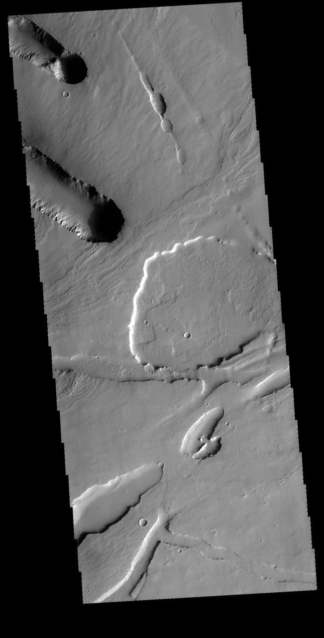 This VIS image shows part of the area where Pavonis Chasma intersects with Pavonis Fossae. It is a region of lava flows from Pavonis Mons and depressions likely formed by collapse into lava tubes and tectonic graben.  Orbit Number: 65596 Latitude: 3.32631 Longitude: 249.947 Instrument: VIS Captured: 2016-09-27 00:55  http://photojournal.jpl.nasa.gov/catalog/PIA21160