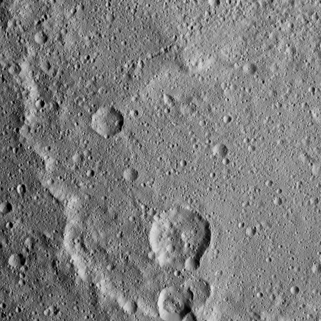 Kerwan Crater, at 174 miles (280 kilometers) in diameter is the largest crater that Dawn has discovered on Ceres. A portion of its jagged rim runs from the top left to bottom center of this image. Kerwan was named for the Hopi spirit of the sprouting maize. Dawn took this image on Oct. 19 from its second extended-mission science orbit (XMO2), at a distance of about 920 miles (1,480 kilometers) above the surface. The image resolution is about 460 feet (140 meters) per pixel. http://photojournal.jpl.nasa.gov/catalog/PIA21232