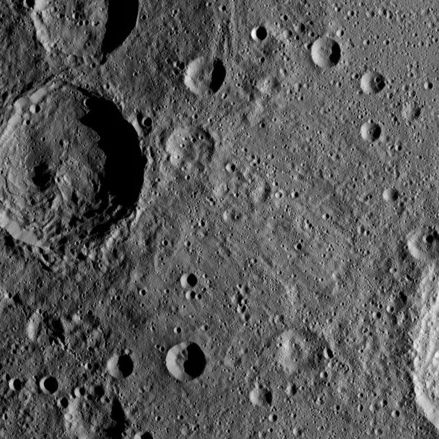 Sintana Crater is seen on the left side of this image of Ceres from NASA's Dawn spacercraft. The crater's central peak casts a shadow over its western flank.  At lower right, the rim of Darzamat peeks into view.  Dawn took this image on Oct. 19 from its second extended-mission science orbit (XMO2), at a distance of about 920 miles (1,480 kilometers) above the surface. The image resolution is about 460 feet (140 meters) per pixel.  http://photojournal.jpl.nasa.gov/catalog/PIA21234