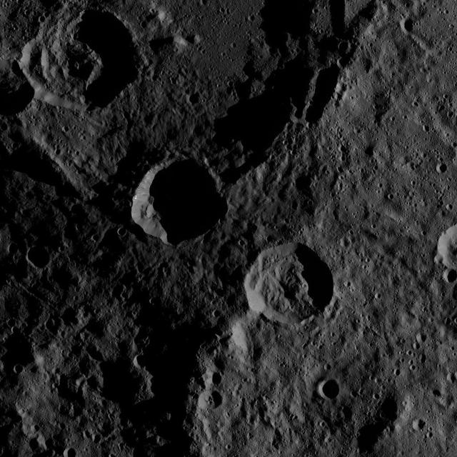 This southern hemisphere scene from dwarf planet Ceres encompasses parts of the craters Mondamin and Darzamat. Mondamin, which is 78 miles (126 kilometers) wide, is the large crater located in the top half of the image. Darzamat, at 57 miles (92 kilometers) wide, is at bottom-right. Dawn took this image on Oct. 19, 2016, from its second extended-mission science orbit (XMO2), at a distance of about 920 miles (1,480 kilometers) above the surface. The image resolution is about 460 feet (140 meters) per pixel. http://photojournal.jpl.nasa.gov/catalog/PIA21235