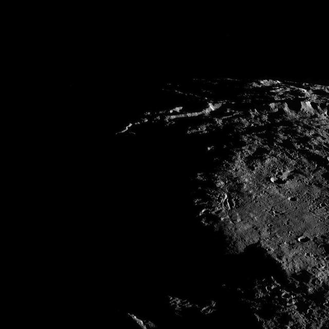 Sunlit cliffs tower above Yalode Crater on Ceres in this shadowy perspective view. At 152 miles (260 kilometers) in diameter, Yalode is one of Ceres' largest craters. A fissure called Nar Sulcus is seen just right of center. Dawn took this image on Oct. 19, 2016, from its second extended-mission science orbit (XMO2), at a distance of about 920 miles (1,480 kilometers) above the surface. The image resolution is about 460 feet (140 meters) per pixel. http://photojournal.jpl.nasa.gov/catalog/PIA21236
