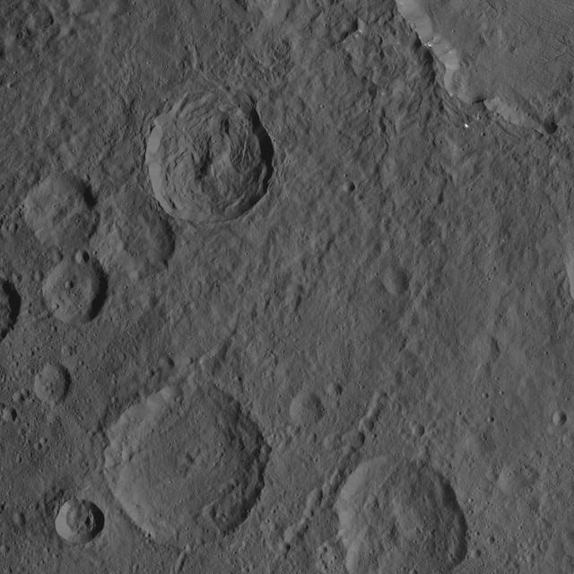 This scene captured by NASA Dawn spacecraft on Oct. 21, 2016, from Ceres northern hemisphere shows part of the rim of Dantu Crater, at top right. Rao Crater is the largest crater in the bottom left corner of the image. Dawn took this image on Oct. 21, 2016, from its second extended-mission science orbit (XMO2), at a distance of about 920 miles (1,480 kilometers) above the surface. The image resolution is about 460 feet (140 meters) per pixel. http://photojournal.jpl.nasa.gov/catalog/PIA21243
