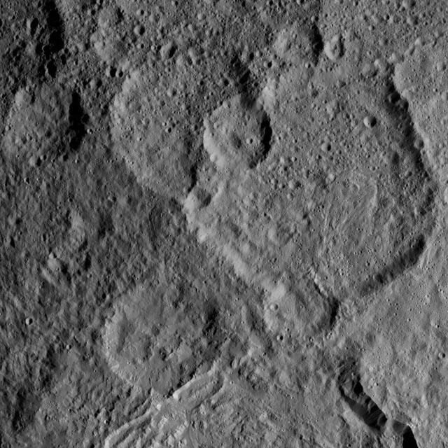This view, taken on Oct. 21, 2016, from NASA Dawn spacecraft shows Megwomets Crater on Ceres. Megwomets is the largest crater in this image, at right of center. The crater is named for a Yurok god of acorns and distributor of vegetal abundance.  Dawn took this image on Oct. 21, 2016, from its second extended-mission science orbit (XMO2), at a distance of about 920 miles (1,480 kilometers) above the surface. The image resolution is about 460 feet (140 meters) per pixel.  http://photojournal.jpl.nasa.gov/catalog/PIA21245