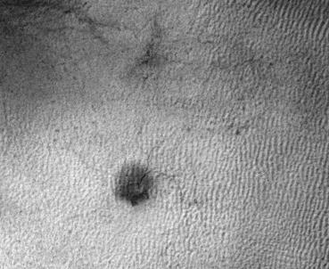 This image from NASA Mars Reconnaissance Orbiter shows the growth of a branching network of troughs carved by thawing carbon dioxide over the span of three Martian years. This process is believed to also form larger radially patterned channel features known as Martian "spiders."  The image is one of three taken by the High Resolution Imaging Science Experiment (HiRISE) camera on NASA's Mars Reconnaissance Orbiter and included in a report on the first detection of such troughs persisting and growing, from one Mars year to the next.   An animation is available at http://photojournal.jpl.nasa.gov/catalog/PIA21257