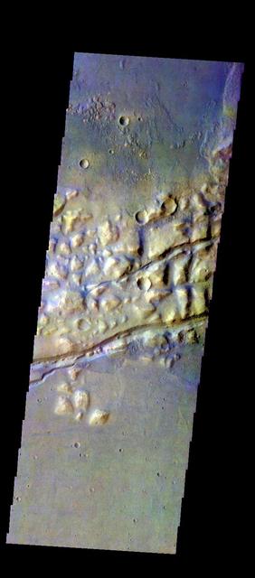 The THEMIS VIS camera contains 5 filters. The data from different filters can be combined in multiple ways to create a false color image. These false color images may reveal subtle variations of the surface not easily identified in a single band image. Today's false color image shows part of Gorgonum Chaos. The linear features are graben that are part of Sirenum Fossae. Orbit Number: 50827 Latitude: -38.1132 Longitude: 188.825 Instrument: VIS Captured: 2013-05-30 01:48 http://photojournal.jpl.nasa.gov/catalog/PIA21279