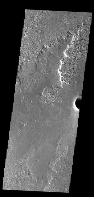 This VIS image shows a small portion of Daedalia Planum. The lava flows in this region originated at Arsia Mons, one of the large Tharsis volcanoes. Several different elevations of lava flow are visible in this image, some much smoother in appearance than others. Orbit Number: 66838 Latitude: -18.1894 Longitude: 231.819 Instrument: VIS Captured: 2017-01-07 07:45 http://photojournal.jpl.nasa.gov/catalog/PIA21321